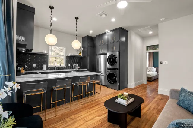 a kitchen with a sink cabinets and living room view