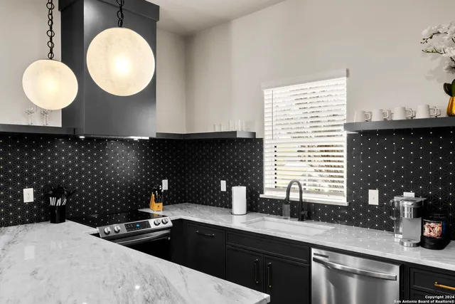 a kitchen with a sink and a stove