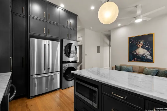 a kitchen with stainless steel appliances a refrigerator and microwave