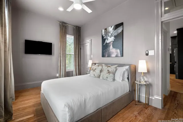 a bedroom with a bed and a flat screen tv