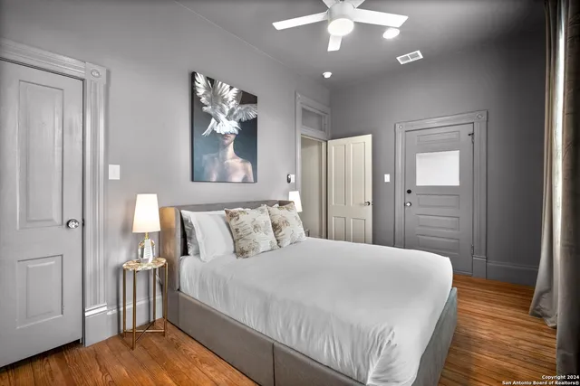 a bedroom with a large bed and a chandelier