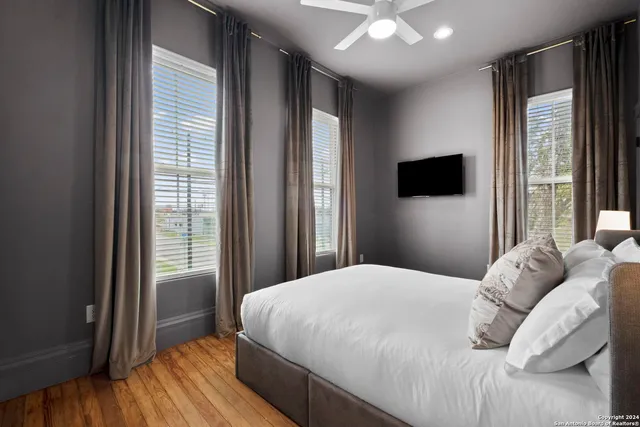 a bedroom with a bed and a large window