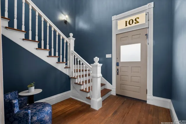 a view of entryway and hall with wooden floor