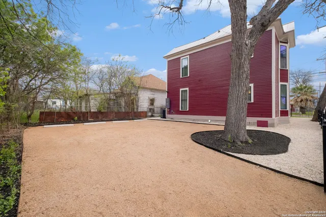 a tall building with trees in front of it