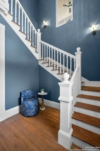a view of entryway and hall with wooden floor