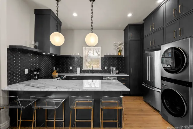 a kitchen with a table chairs and a sink