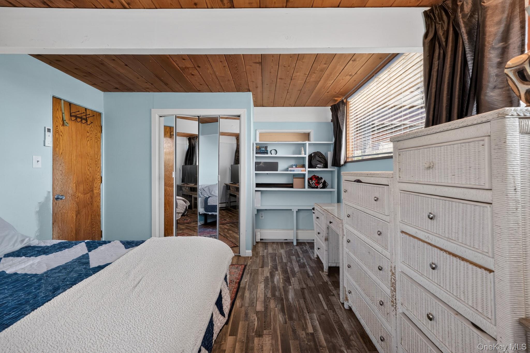 424 Laroe Road Chester, NY 10918 - Photo 12 of 43 Wood-finish flooring throughout, complemented by a wood-plank ceiling with exposed white beams