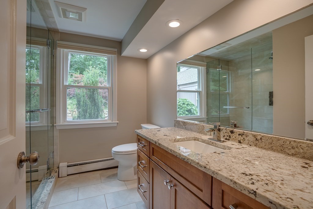 45 Towne Road Boxford, MA 01921 - Photo 36 of 42 a bathroom with a granite countertop sink a toilet and a mirror