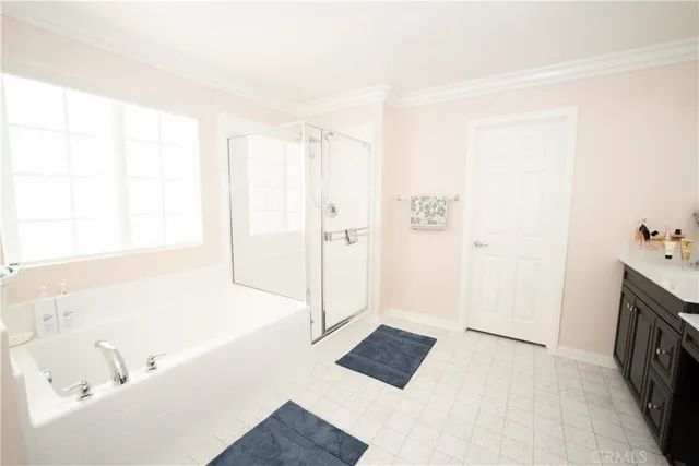 a bedroom with a bed dresser and a window