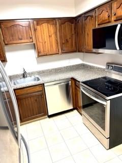307 South Dithridge Street, Unit 11 Pittsburgh, PA 15213 - Photo 12 of 25 a kitchen with granite countertop a stove top oven cabinetry a sink and a counter