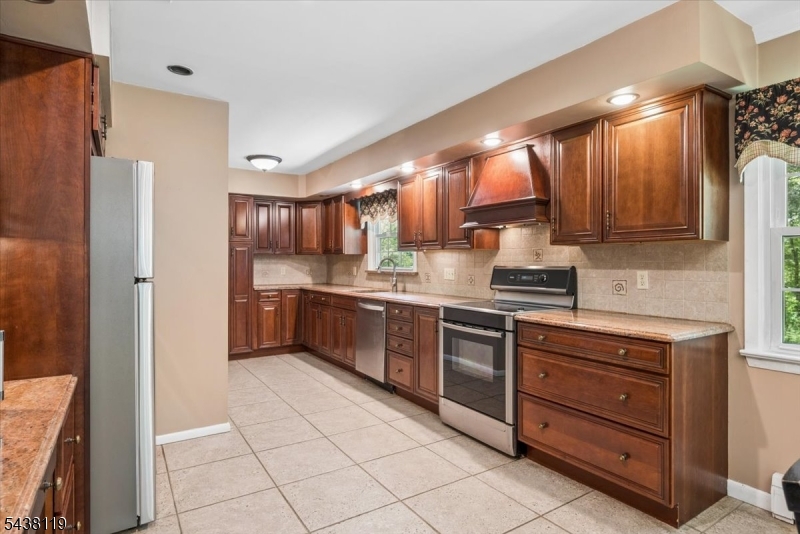 335 Drakestown Road Long Valley, NJ 07853 - Photo 11 of 34 a kitchen with stainless steel appliances a sink and a refrigerator