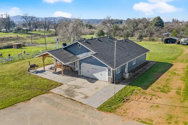 an aerial view of a house with a big yard