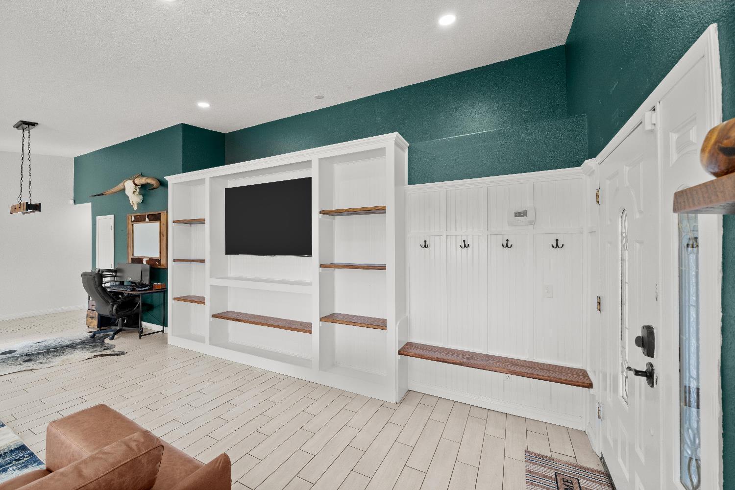 5224 Fruitland Road Marysville, CA 95901 - Photo 21 of 51 a living room with a flat screen tv on dresser and a wooden floor