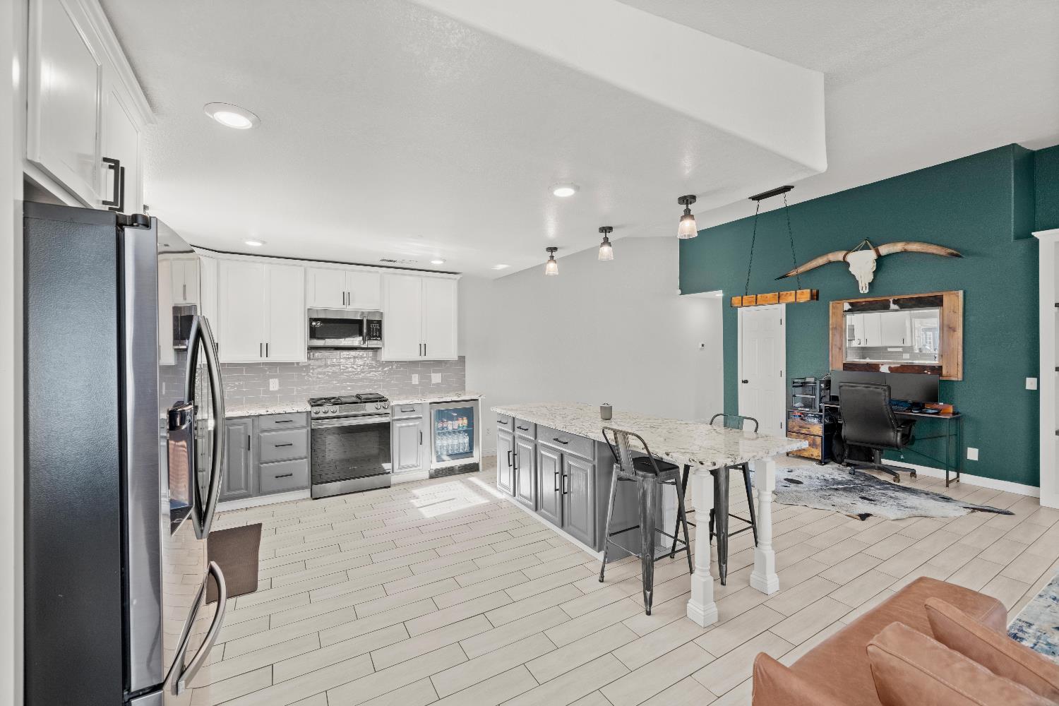 5224 Fruitland Road Marysville, CA 95901 - Photo 22 of 51 a kitchen with stainless steel appliances kitchen island granite countertop a refrigerator oven a sink dishwasher and white cabinets with wooden floor