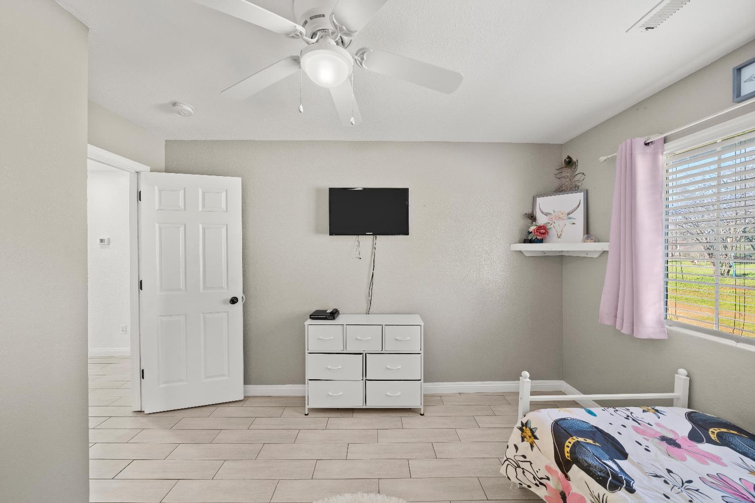 5224 Fruitland Road Marysville, CA 95901 - Photo 34 of 51 a bedroom with a bed and a lamp on the dresser
