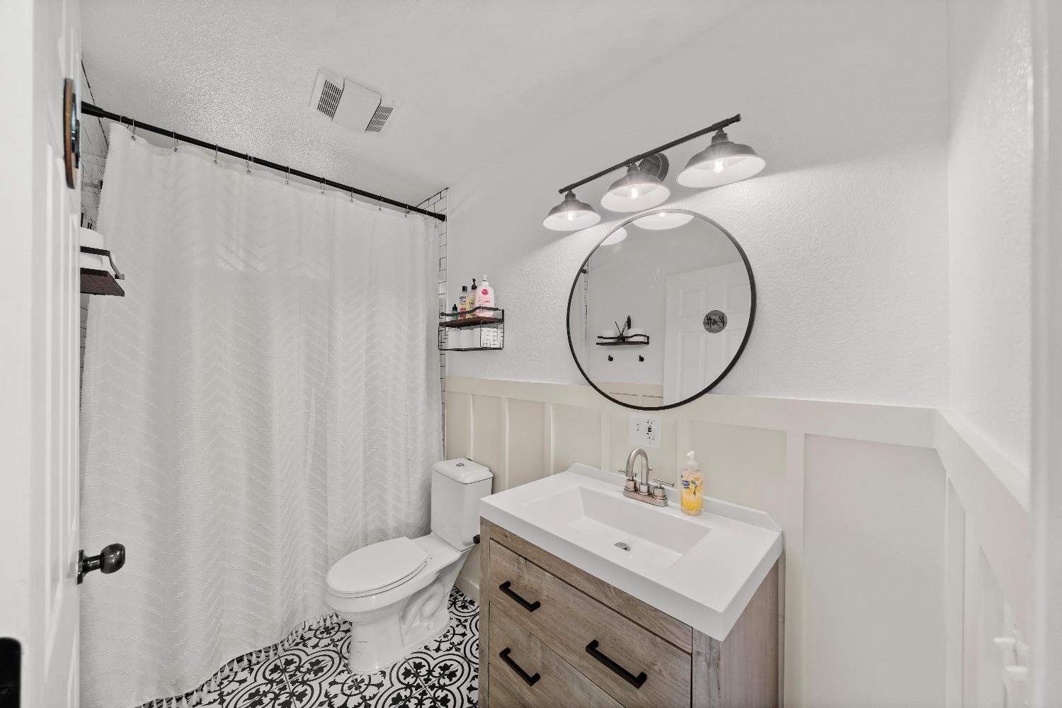 5224 Fruitland Road Marysville, CA 95901 - Photo 37 of 51 a bathroom with a sink toilet and a mirror