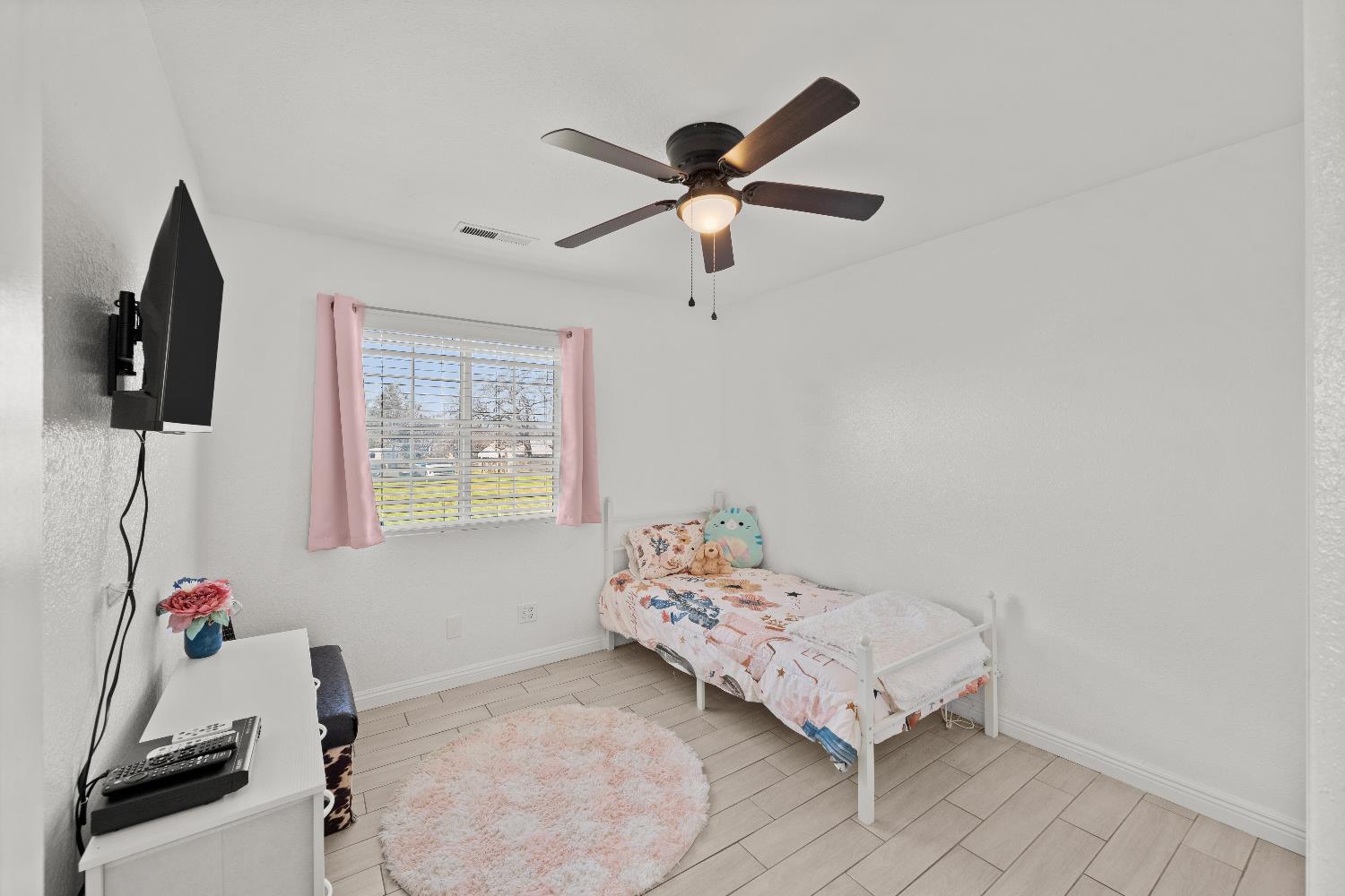 5224 Fruitland Road Marysville, CA 95901 - Photo 39 of 51 a bedroom with a bed and a flat screen tv