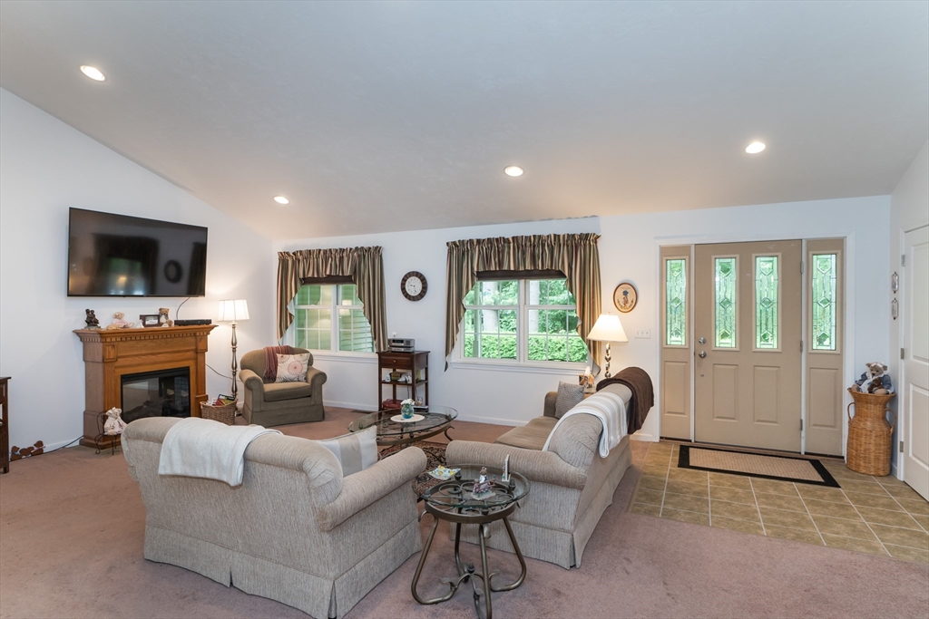 216 Palmer Road Brimfield, MA 01010 - Photo 11 of 25 a living room with furniture a fireplace and a flat screen tv