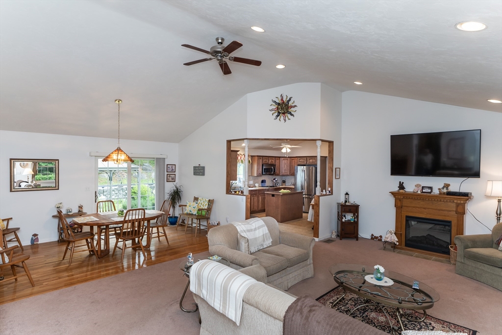 216 Palmer Road Brimfield, MA 01010 - Photo 12 of 25 a living room with furniture a flat screen tv and a chandelier