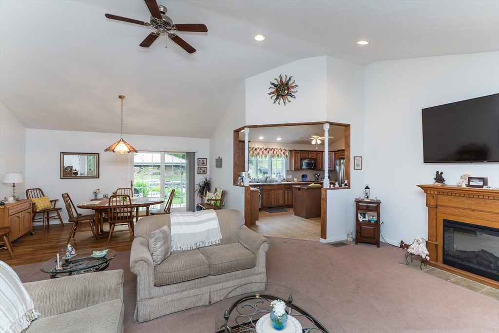 216 Palmer Road Brimfield, MA 01010 - Photo 13 of 25 a living room with furniture a fireplace and a flat screen tv