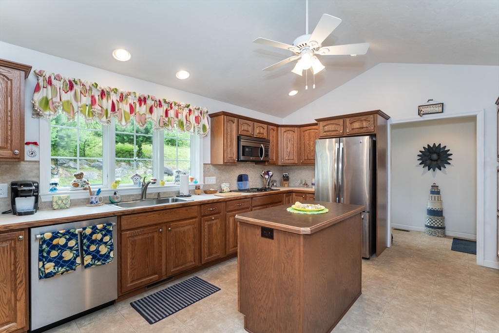 216 Palmer Road Brimfield, MA 01010 - Photo 16 of 25 a kitchen with stainless steel appliances granite countertop a refrigerator a sink dishwasher and white cabinets with wooden floor