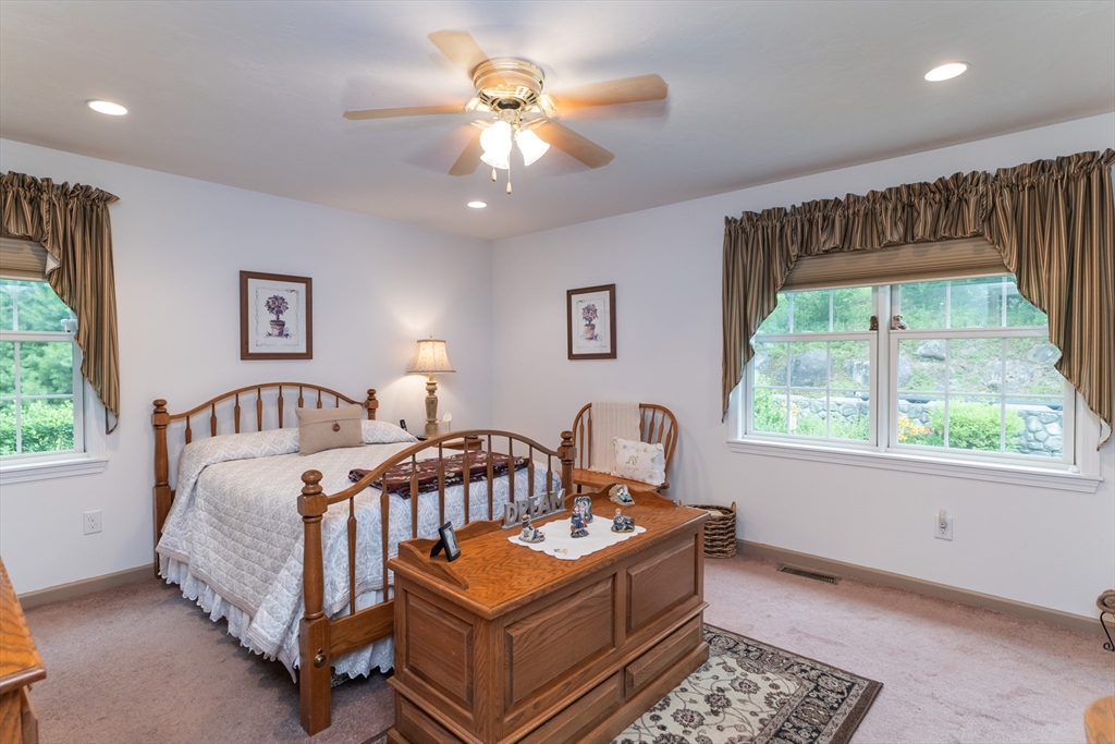 216 Palmer Road Brimfield, MA 01010 - Photo 20 of 25 a bedroom with a bed and a chandelier