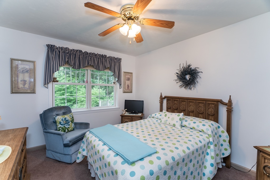 216 Palmer Road Brimfield, MA 01010 - Photo 24 of 25 a bedroom with a bed and a chandelier