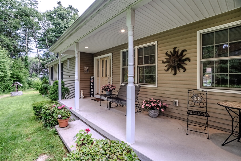 216 Palmer Road Brimfield, MA 01010 - Photo 3 of 25 a view of a patio with table and chairs and potted plants