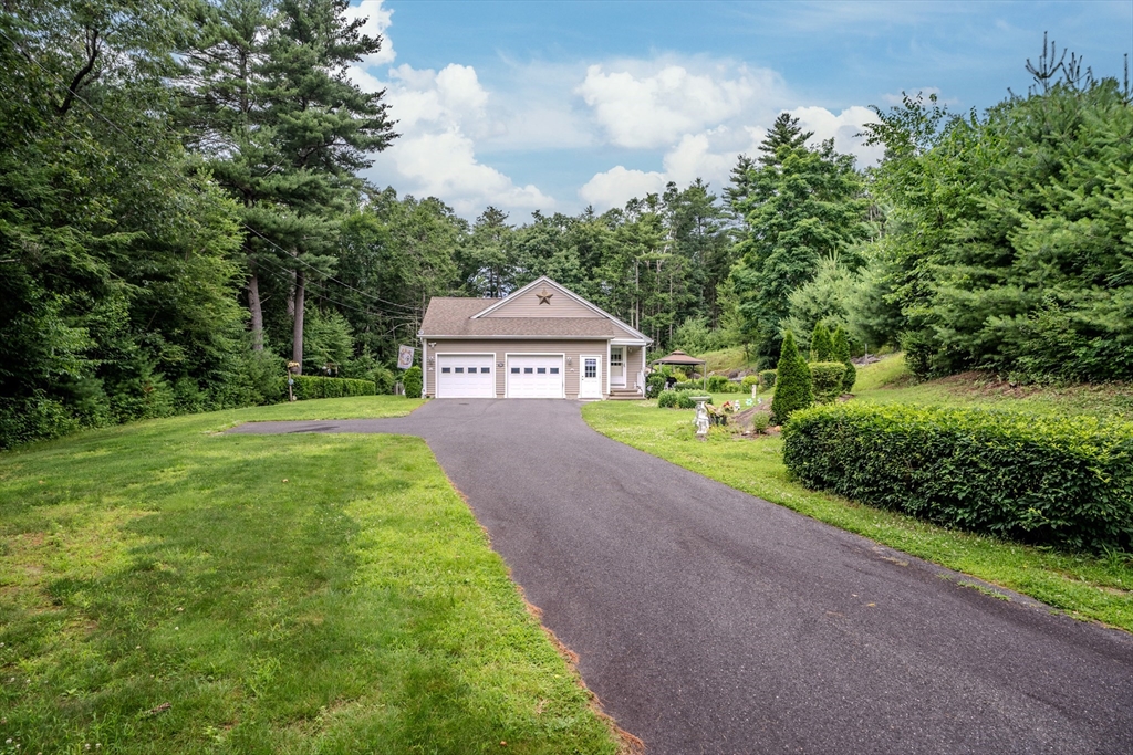 216 Palmer Road Brimfield, MA 01010 - Photo 6 of 25 a pathway of a house with a big yard and large trees