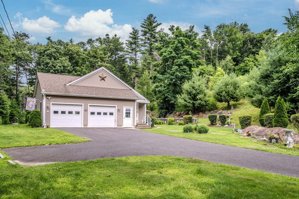 216 Palmer Road Brimfield, MA 01010 - Photo 7 of 25 a front view of a house with a yard and garage