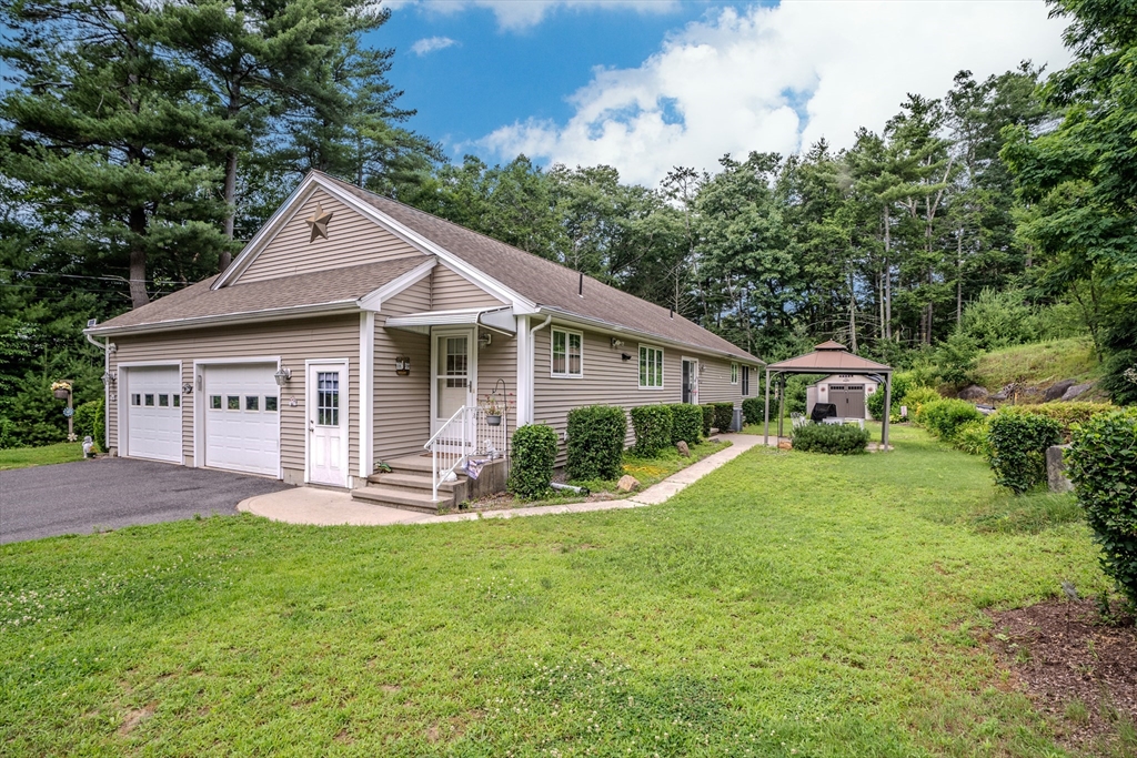 216 Palmer Road Brimfield, MA 01010 - Photo 8 of 25 a front view of a house with a yard and porch