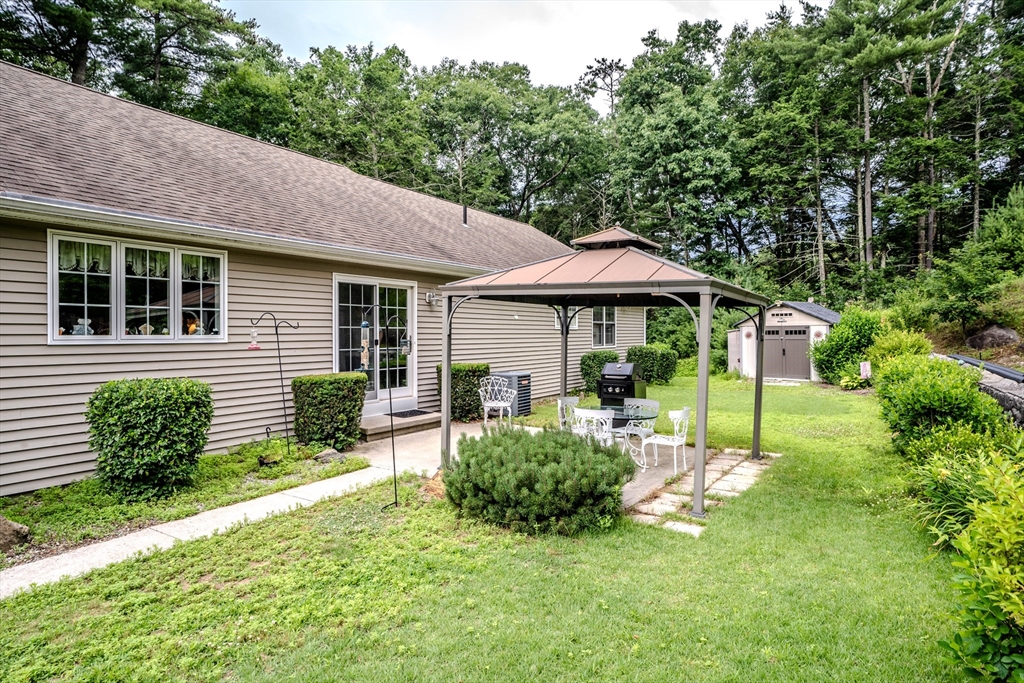 216 Palmer Road Brimfield, MA 01010 - Photo 9 of 25 a front view of a house with a yard table and chairs