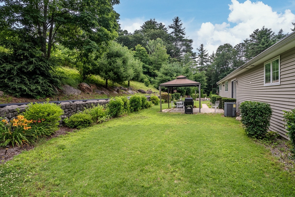 216 Palmer Road Brimfield, MA 01010 - Photo 10 of 25 a view of a table and chairs under an umbrella