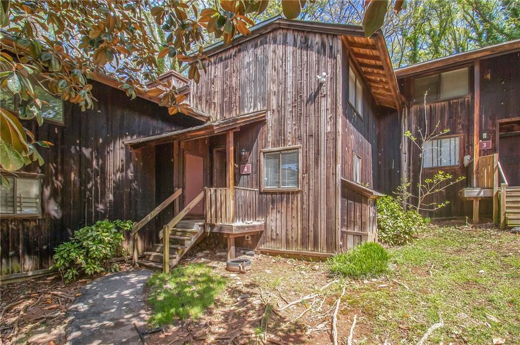 a front view of a house with plants