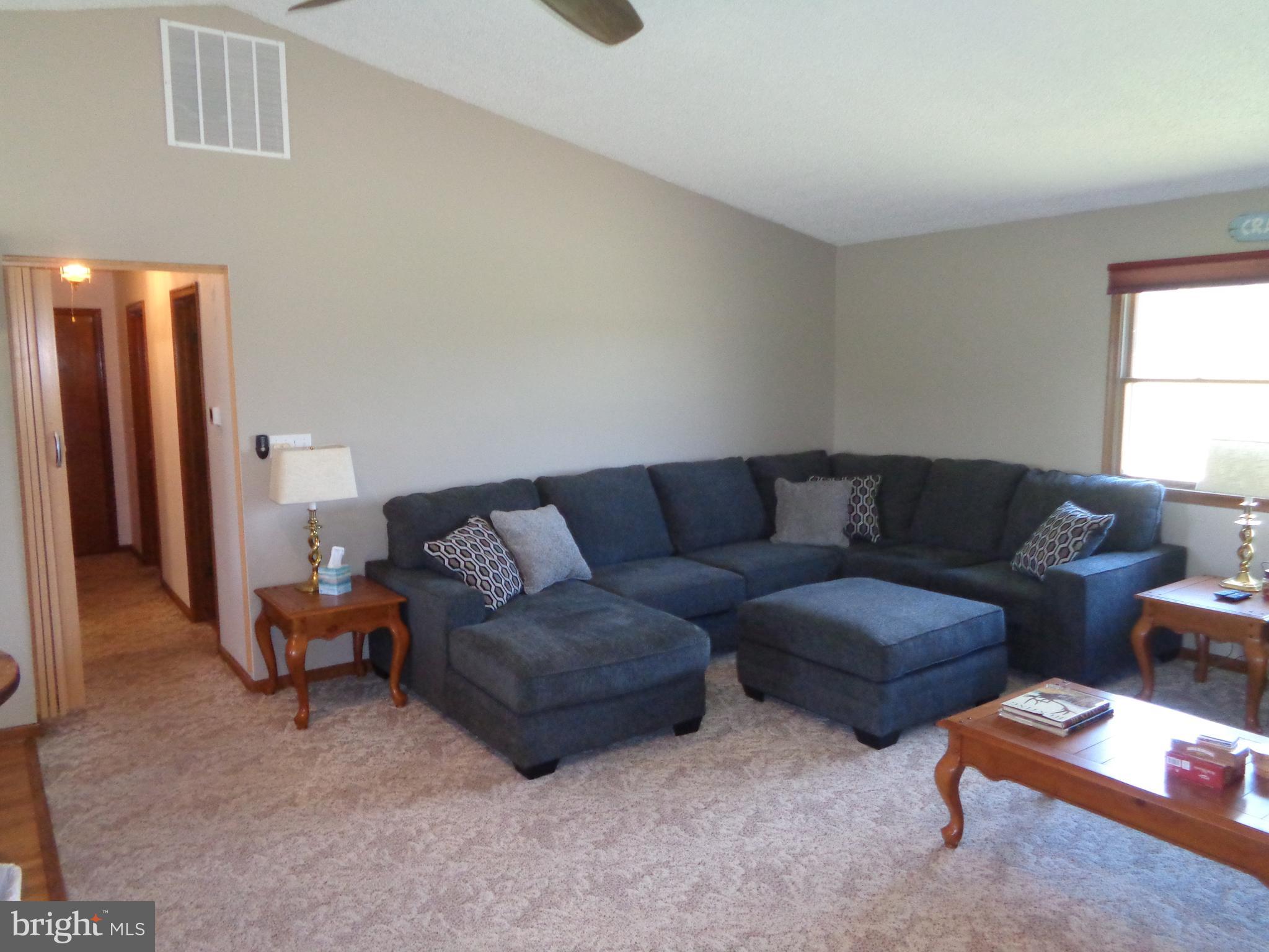 27174 Champ Wharf Road Princess Anne, MD 21853 - Photo 13 of 32 a living room with furniture and a window