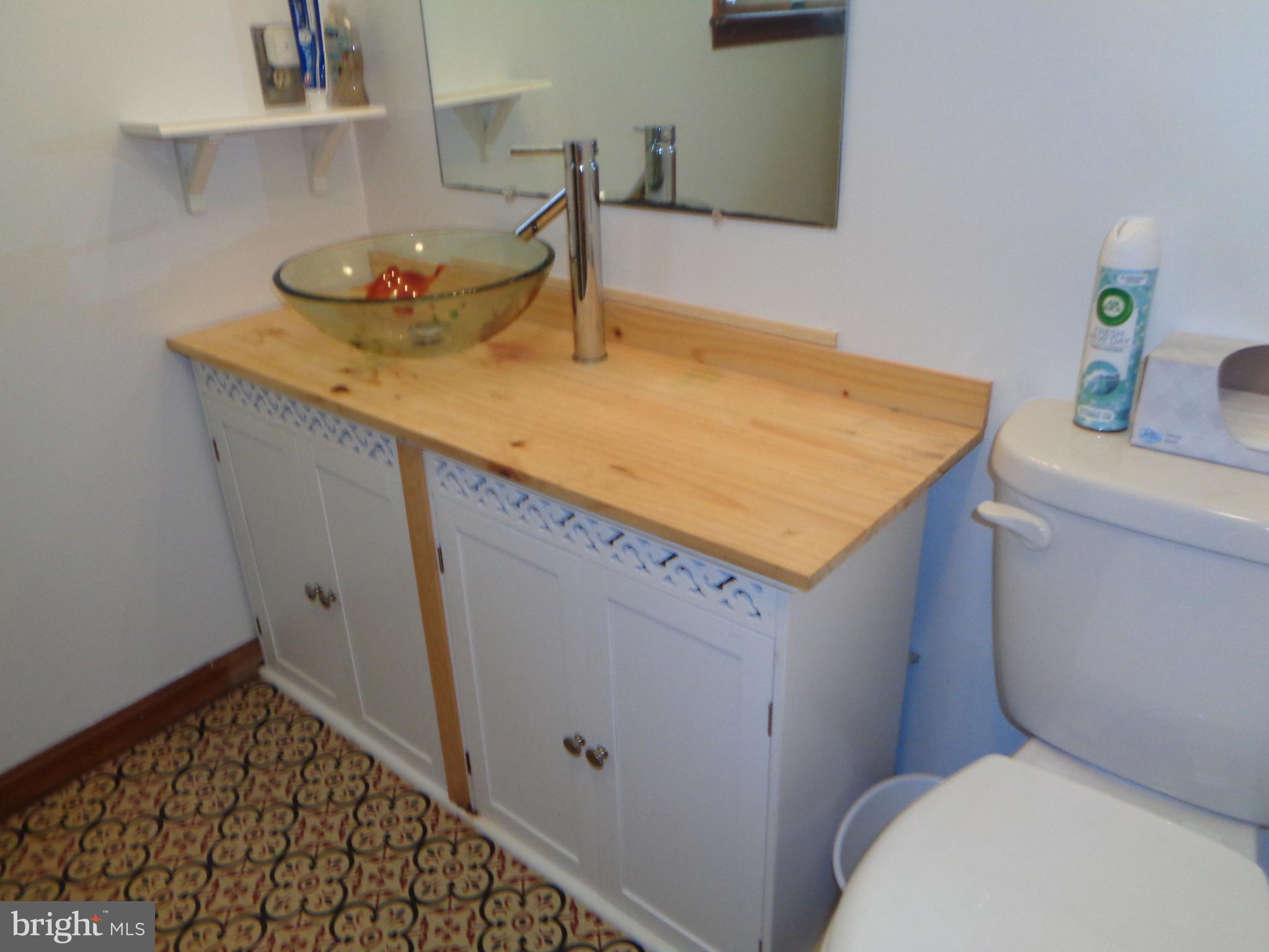 27174 Champ Wharf Road Princess Anne, MD 21853 - Photo 17 of 32 a bathroom with a granite countertop sink and a toilet