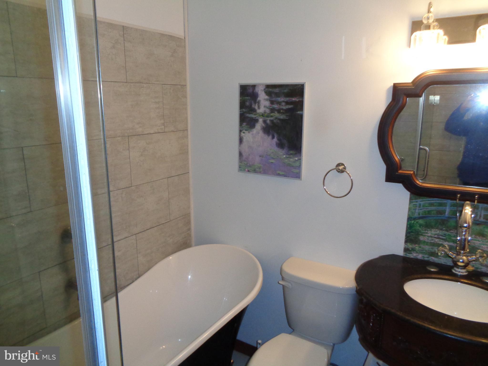 27174 Champ Wharf Road Princess Anne, MD 21853 - Photo 19 of 32 a bathroom with a toilet a sink and mirror