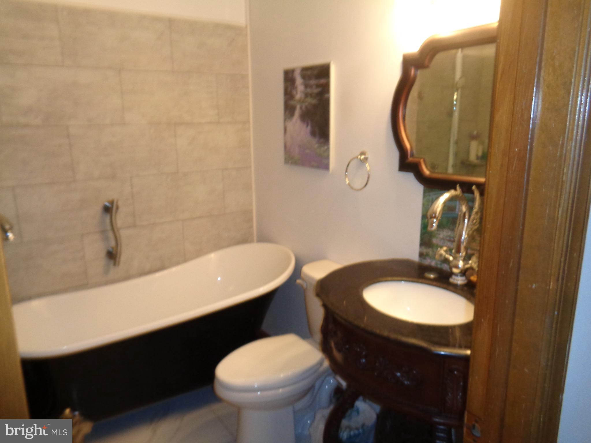 27174 Champ Wharf Road Princess Anne, MD 21853 - Photo 20 of 32 a bathroom with a sink and a mirror