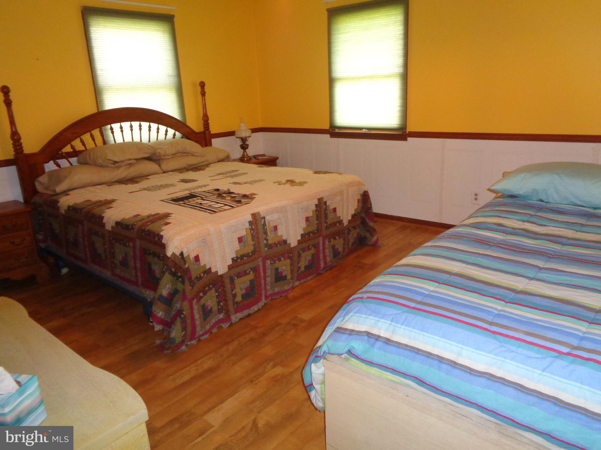 27174 Champ Wharf Road Princess Anne, MD 21853 - Photo 22 of 32 a bedroom with a bed and a window