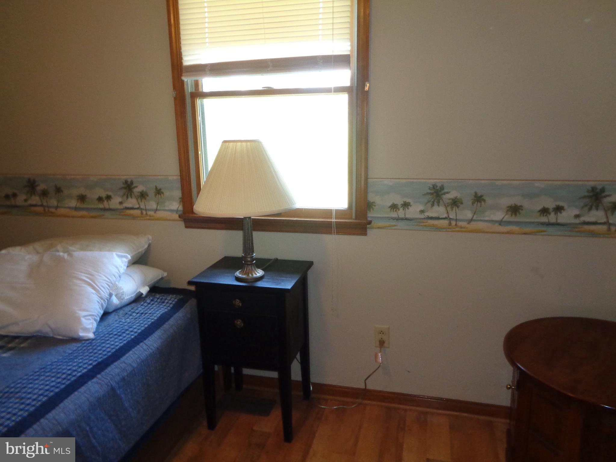 27174 Champ Wharf Road Princess Anne, MD 21853 - Photo 25 of 32 a room with a table chair and a window