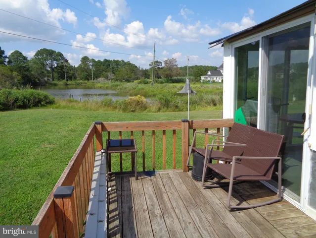 a view of a deck with chairs and a yard