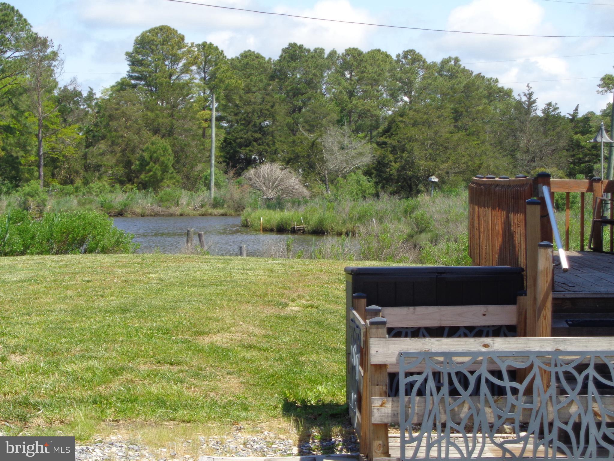 27174 Champ Wharf Road Princess Anne, MD 21853 - Photo 8 of 32 a view of a yard with an outdoor seating