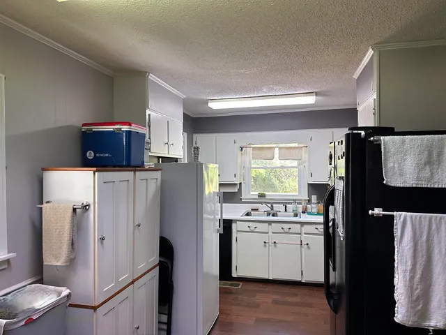 a kitchen with stainless steel appliances a refrigerator sink and microwave