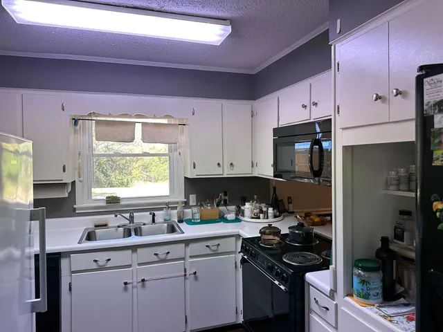 a kitchen with a sink stove and cabinets