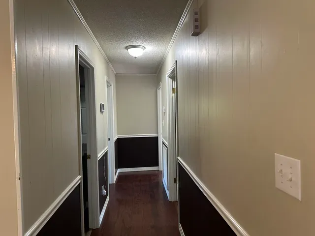 a view of hallway with wooden floor
