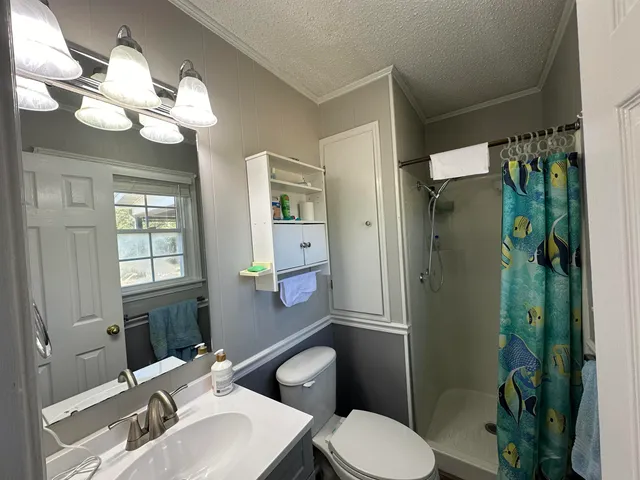 a bathroom with a toilet a sink and shower
