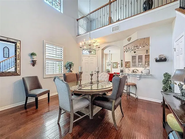 a view of a a dining room with furniture window and wooden floor