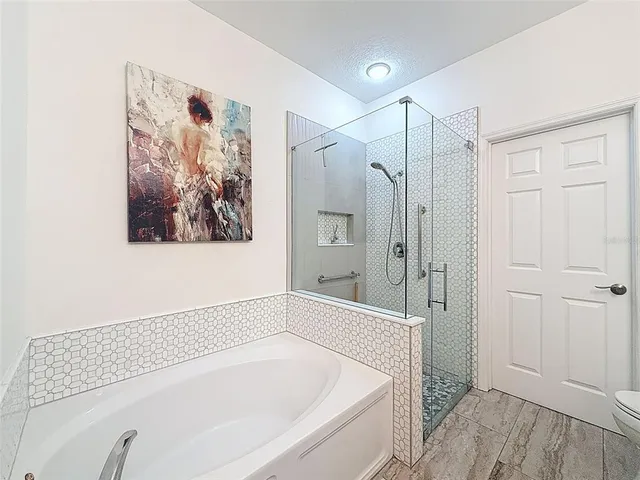 a bathroom with a bathtub and a shower