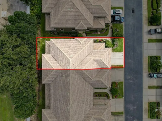 an aerial view of a house with a yard