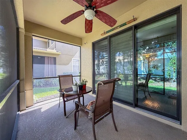 a dining room with furniture and a floor to ceiling window